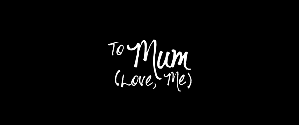 A black background with white text reading "To Mum (Love, Me)" in handwriting. 